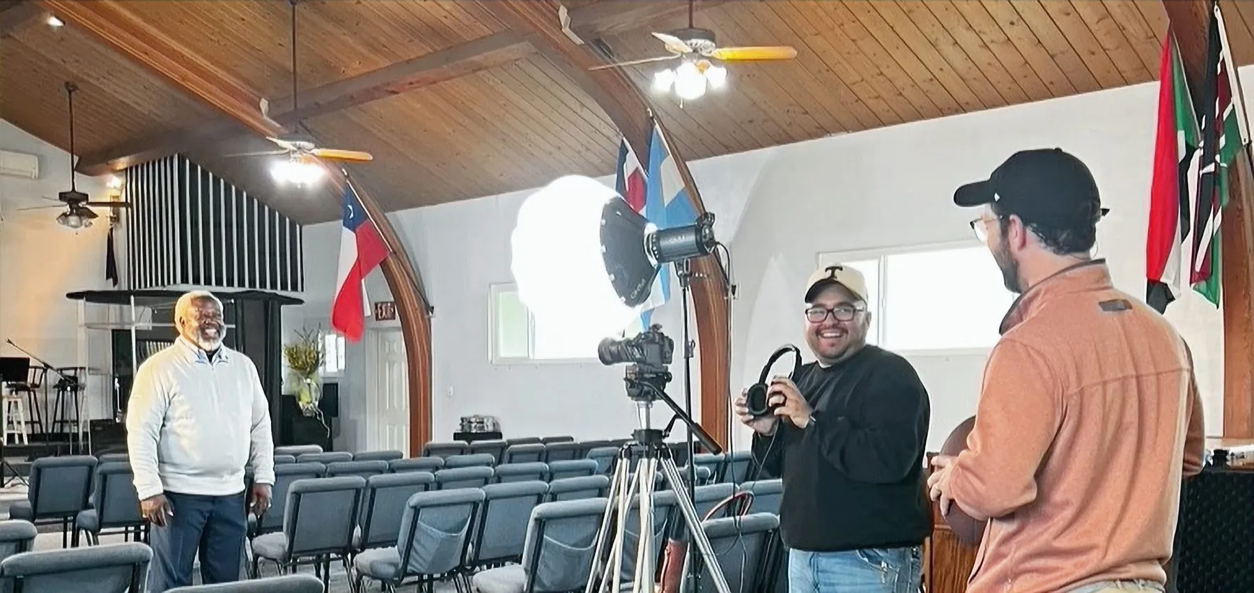 A video shoot in progress in a church fellowship hall.